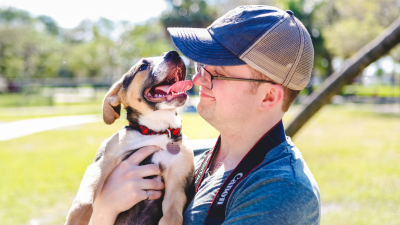 Happy dog dad spending time with their puppy.